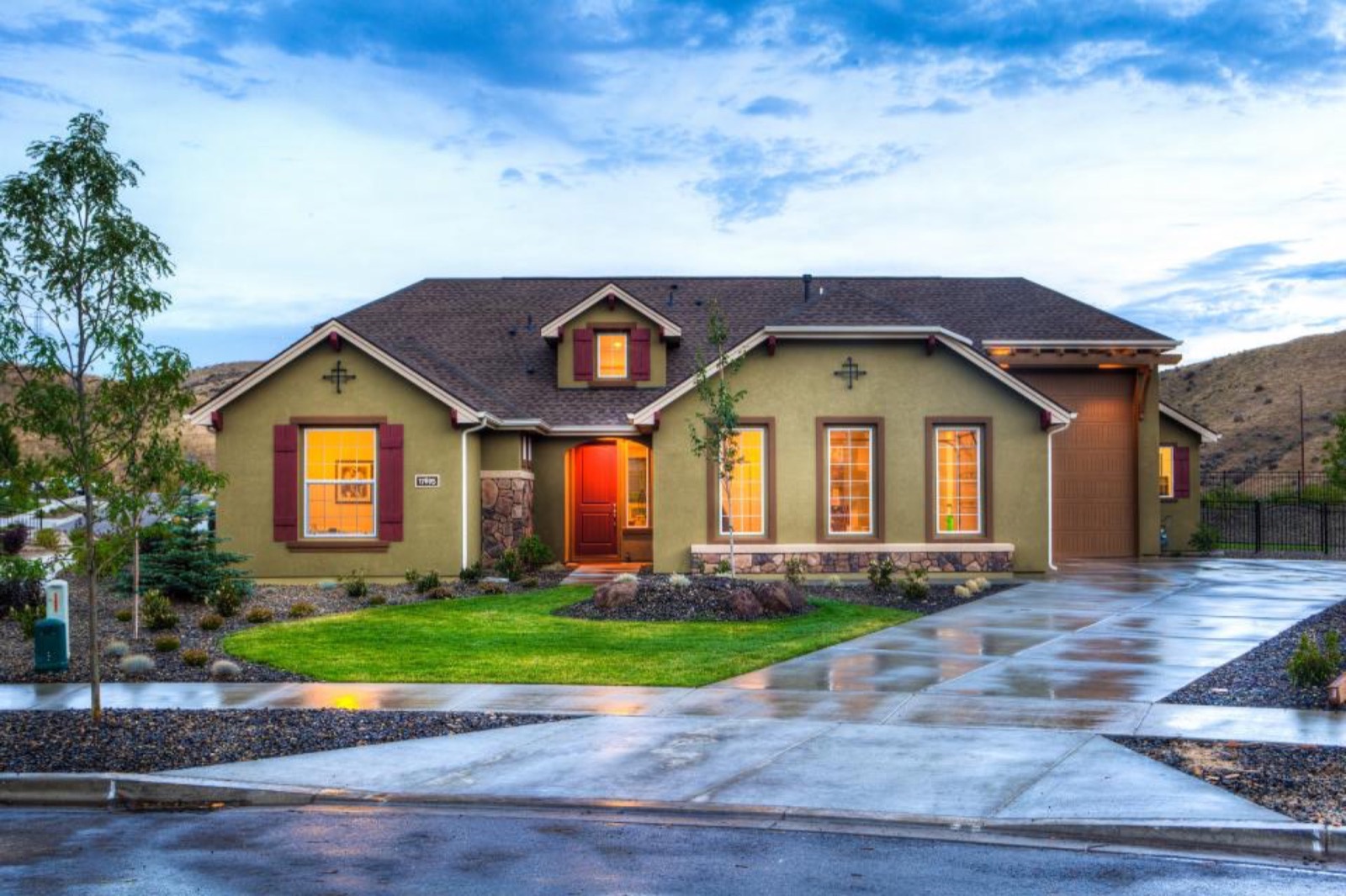 Single-story ranch home with stone accents and a wide driveway